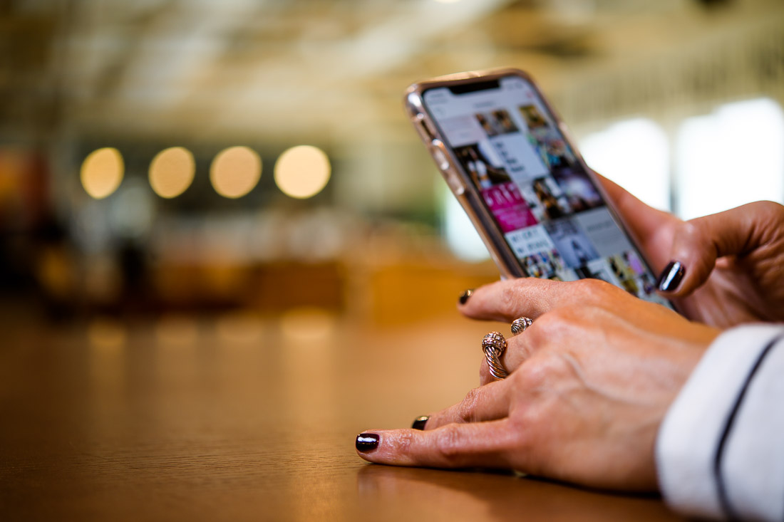 branded lifestyle portrait fitness &amp; health coach Kristi Data checking phone apps