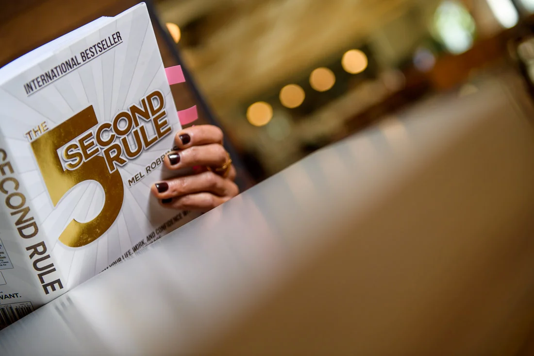 branded lifestyle portrait fitness &amp; health coach Kristi Data reading 5 second rule