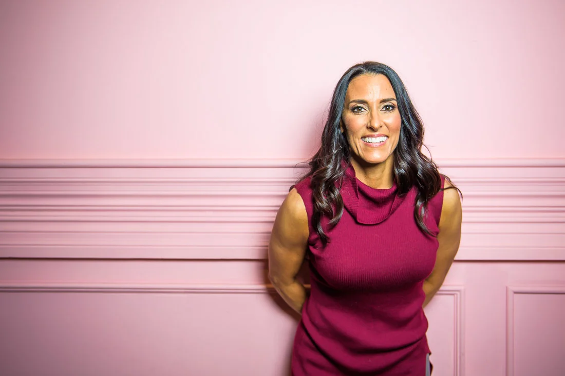 branded lifestyle portrait fitness &amp; health coach Kristi Data portrait leaning on wall