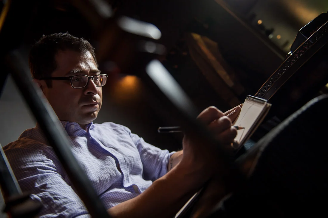 NYC Branded Lifestyle Portraits Cigar Merchant Luis Paredes sketching in pad