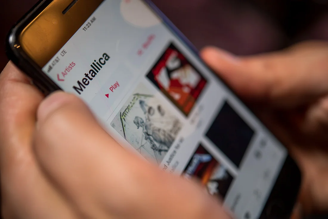 NYC Branded Lifestyle Portraits Cigar Merchant Luis Paredes closeup itunes on his phone