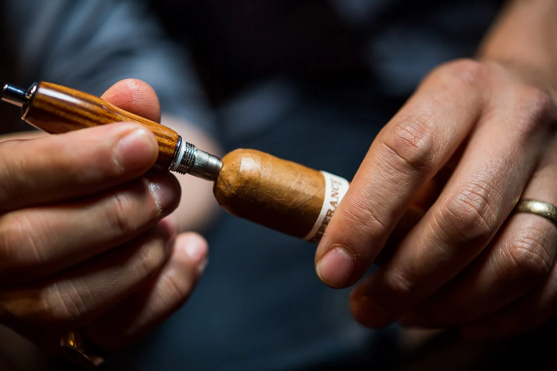 NYC Branded Lifestyle Portraits Cigar Merchant Luis Paredes using cigar punch