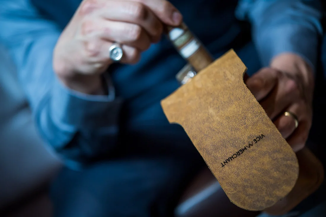 NYC Branded Lifestyle Portraits Cigar Merchant Luis Paredes grabbing cigar out case
