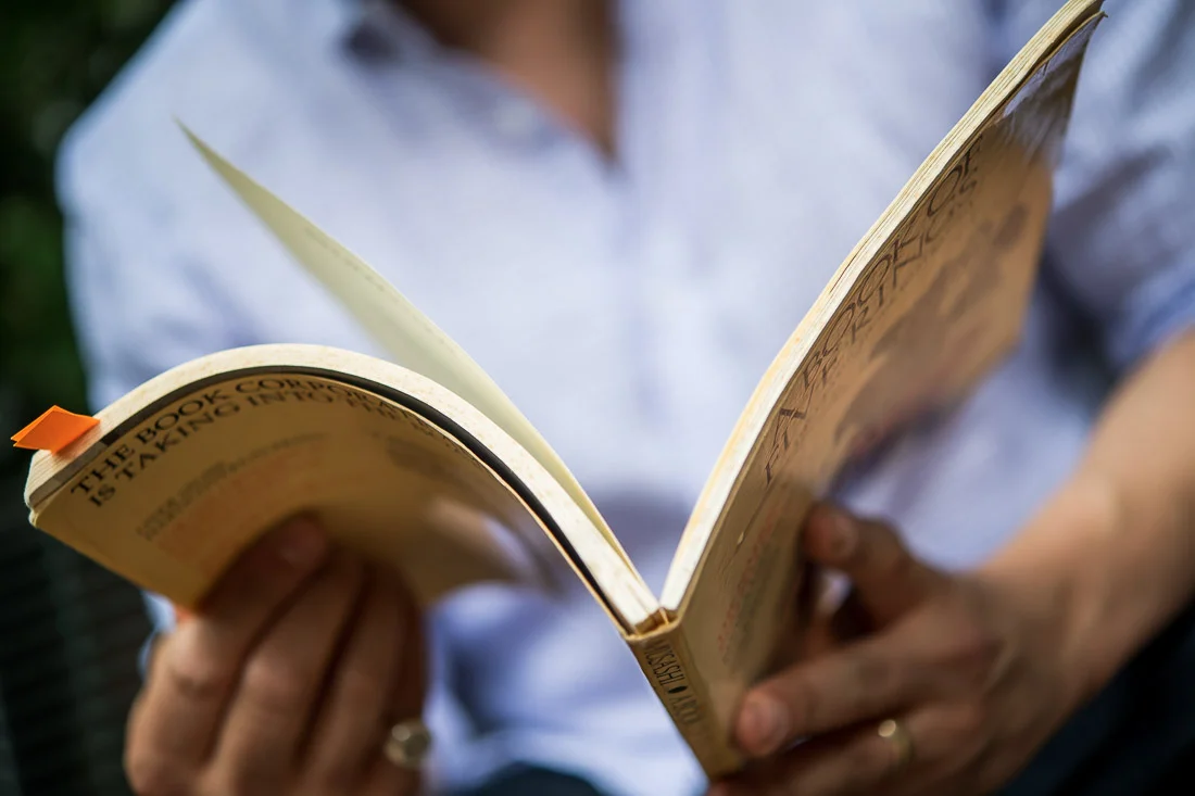 NYC Branded Lifestyle Portraits Cigar Merchant Luis Paredes flipping through book