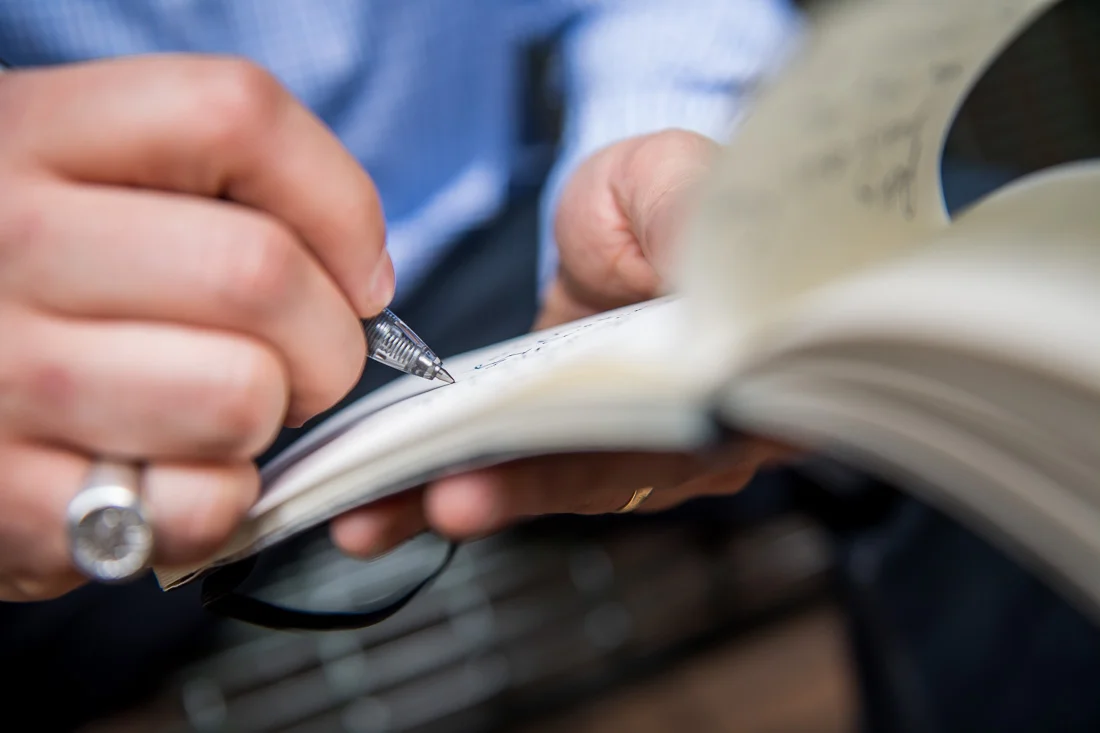 NYC Branded Lifestyle Portraits Cigar Merchant Luis Paredes hands writing in notepad