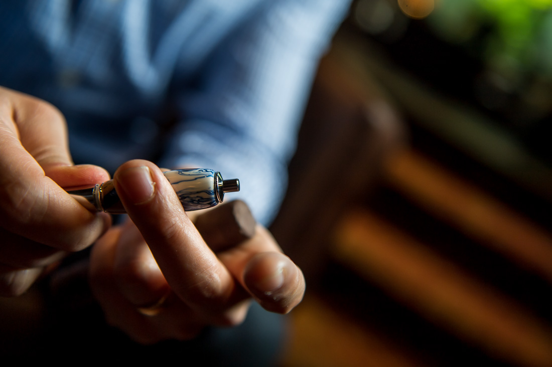 NYC Branded Lifestyle Portraits Cigar Merchant Luis Paredes with cigar punch in hand