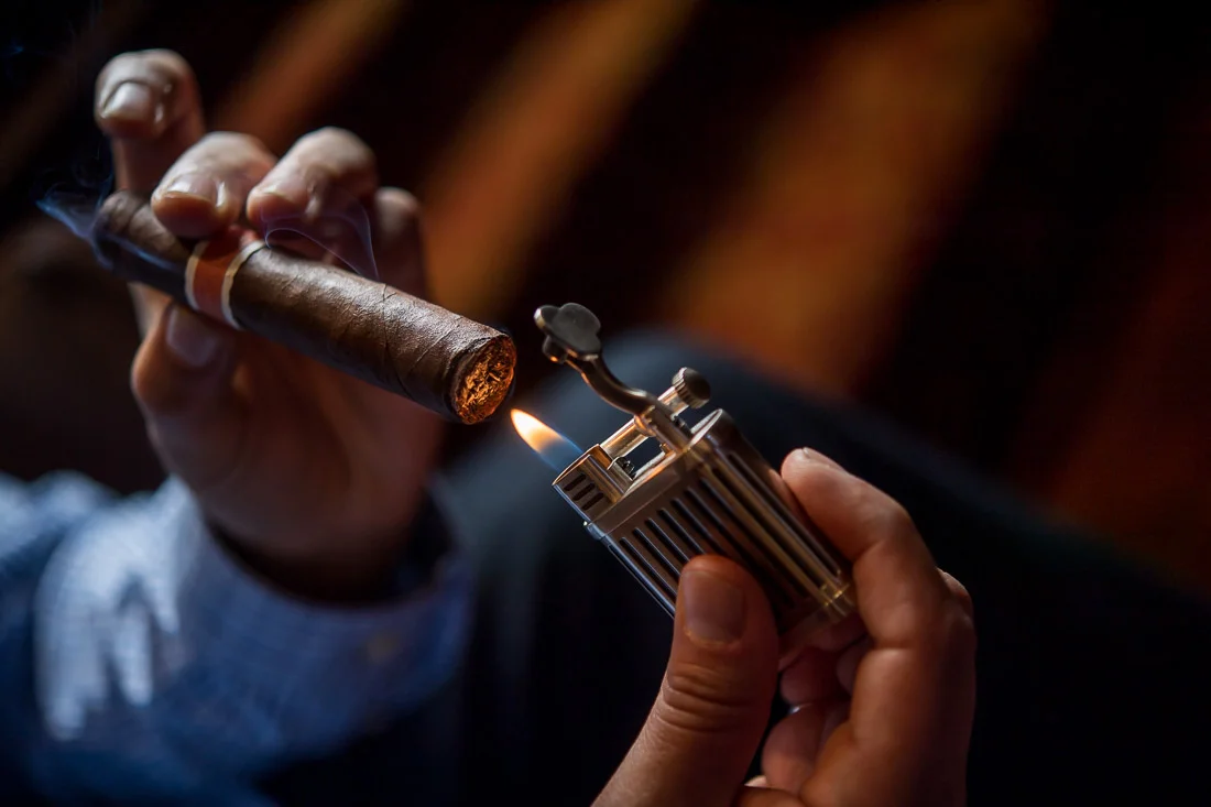 NYC Branded Lifestyle Portraits Cigar Merchant Luis Paredes toasting a cigar