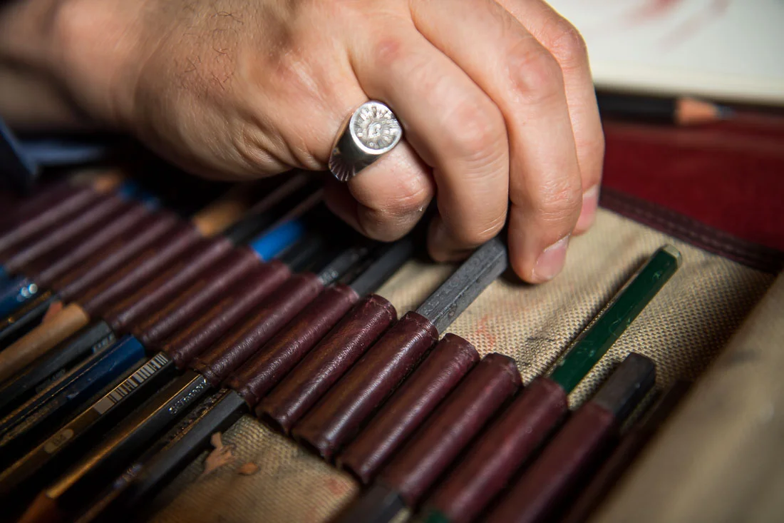 NYC Branded Lifestyle Portraits Cigar Merchant Luis Paredes grabbing for chalk piece