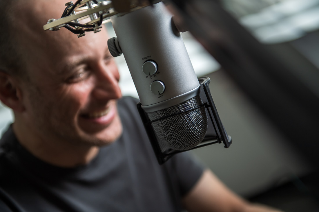 NYC Branded Lifestyle Portraits Speaker Thrive Lou Diamond smiling while podcasting