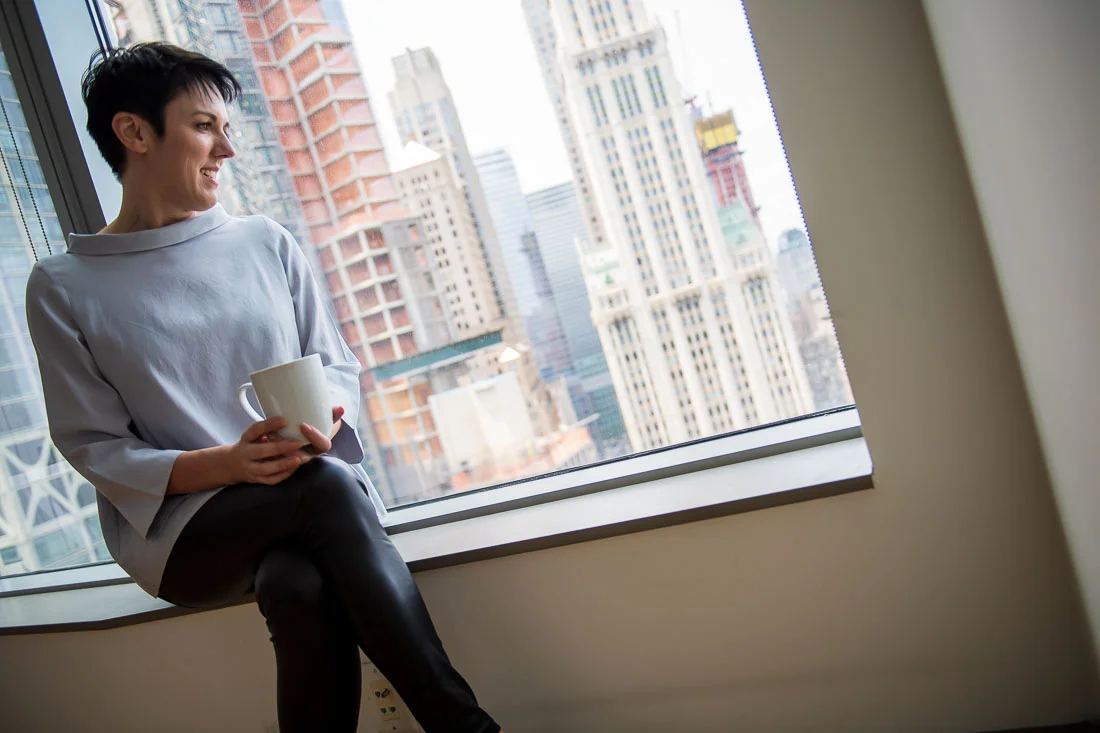 NYC Branded Lifestyle Portraits speaker image consultant Sylvie diGiusto looking out window