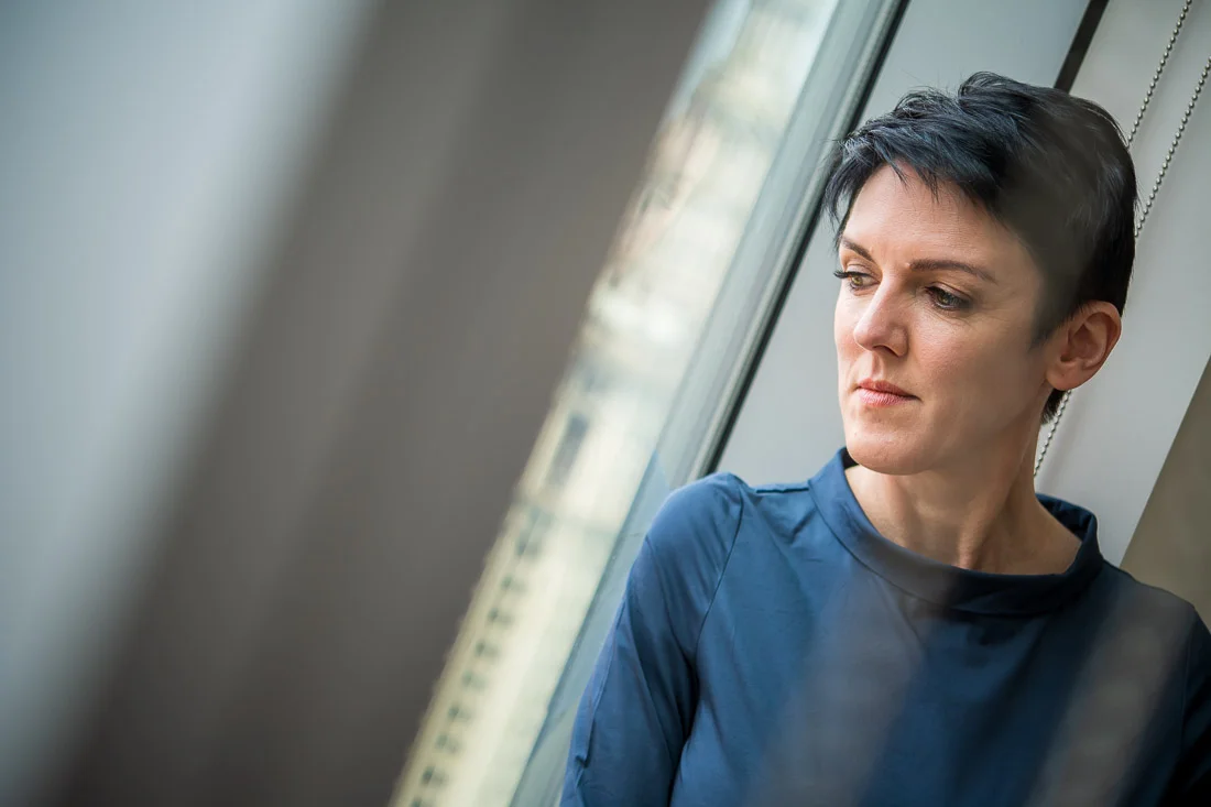 NYC Branded Lifestyle Portraits speaker image consultant Sylvie diGiusto pensive stare out window