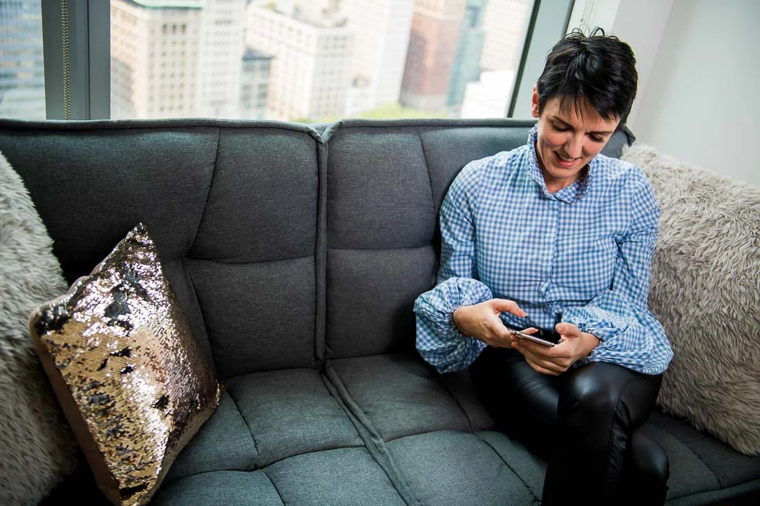 NYC Branded Lifestyle Portraits speaker image consultant Sylvie diGiusto checking her phone