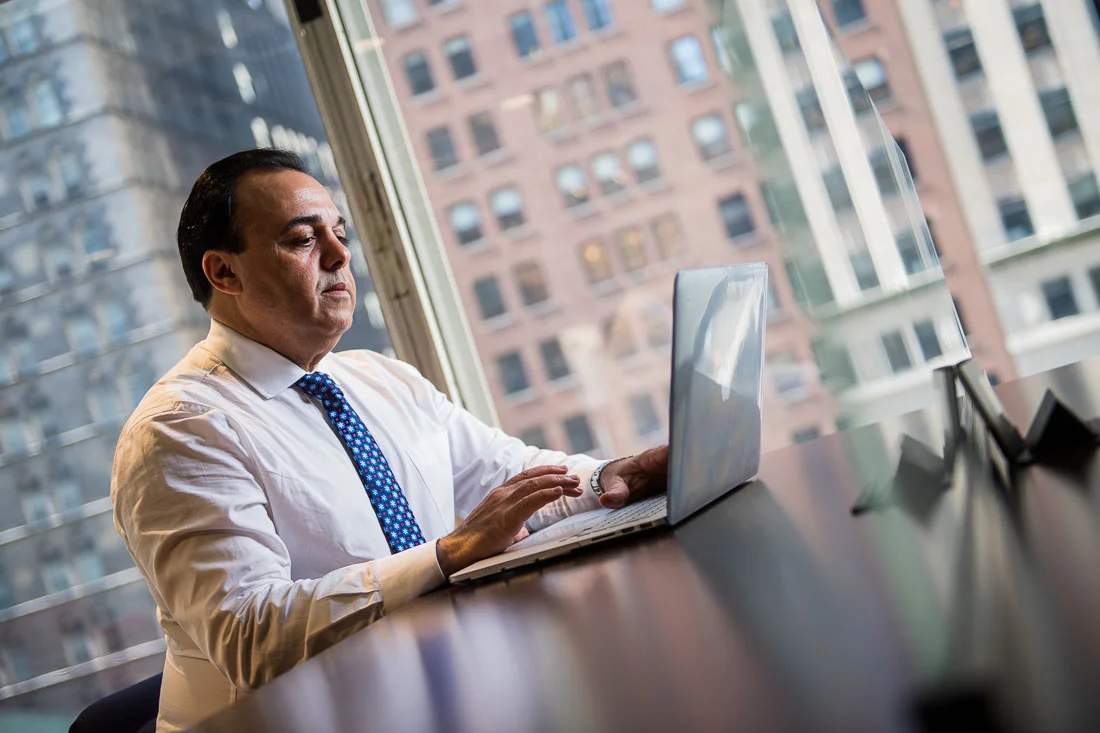 NYC Branded Lifestyle Portraits Sales Executive Speaker Anthony Chaine working on laptop