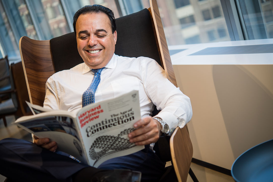 NYC Branded Lifestyle Portraits Sales Executive Speaker Anthony Chaine reading a magazine