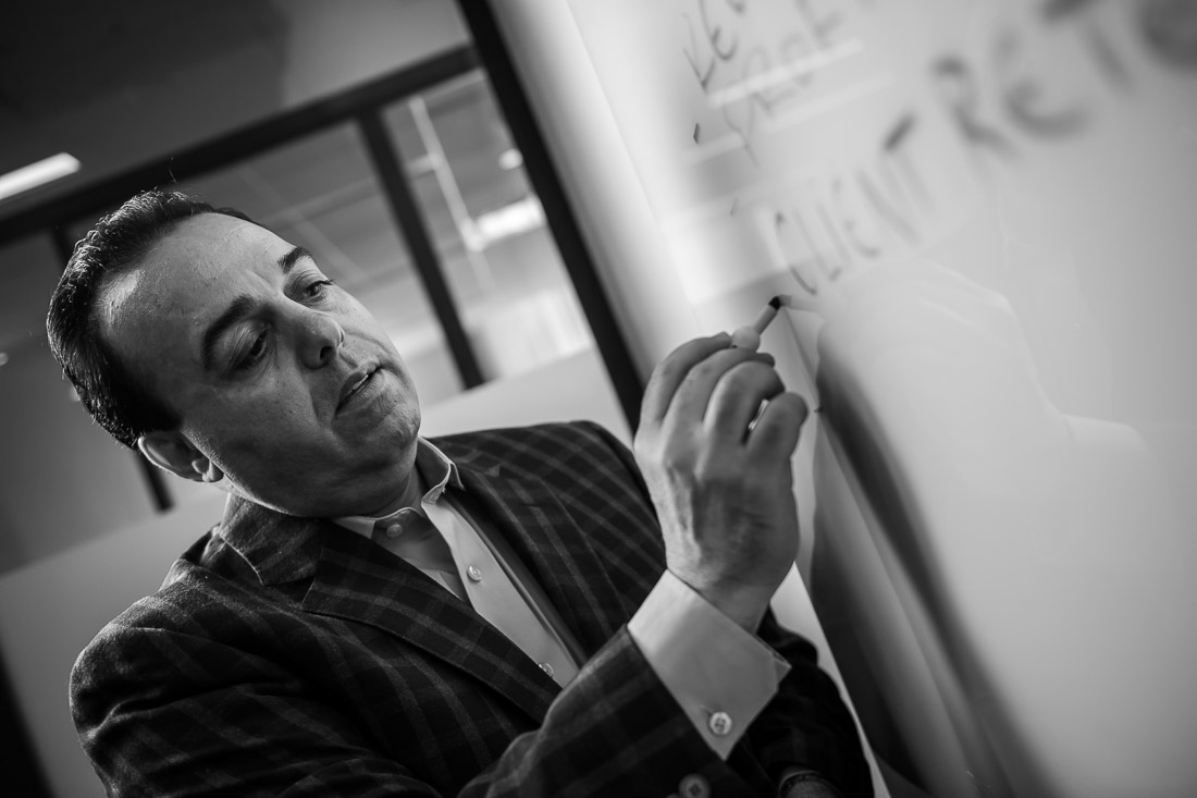 NYC Branded Lifestyle Portraits Sales Executive Speaker Anthony Chaine writing on whiteboard