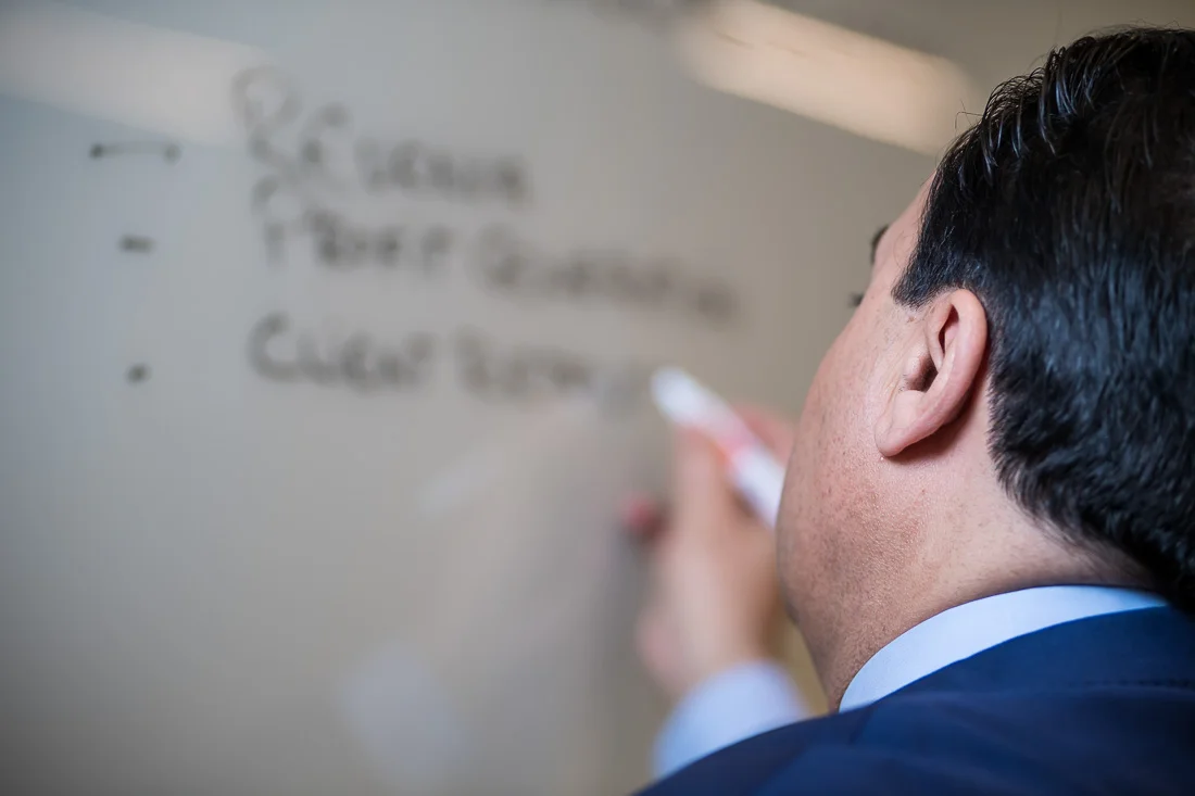 NYC Branded Lifestyle Portraits Sales Executive Speaker Anthony Chaine lecturing and writing on whiteboard