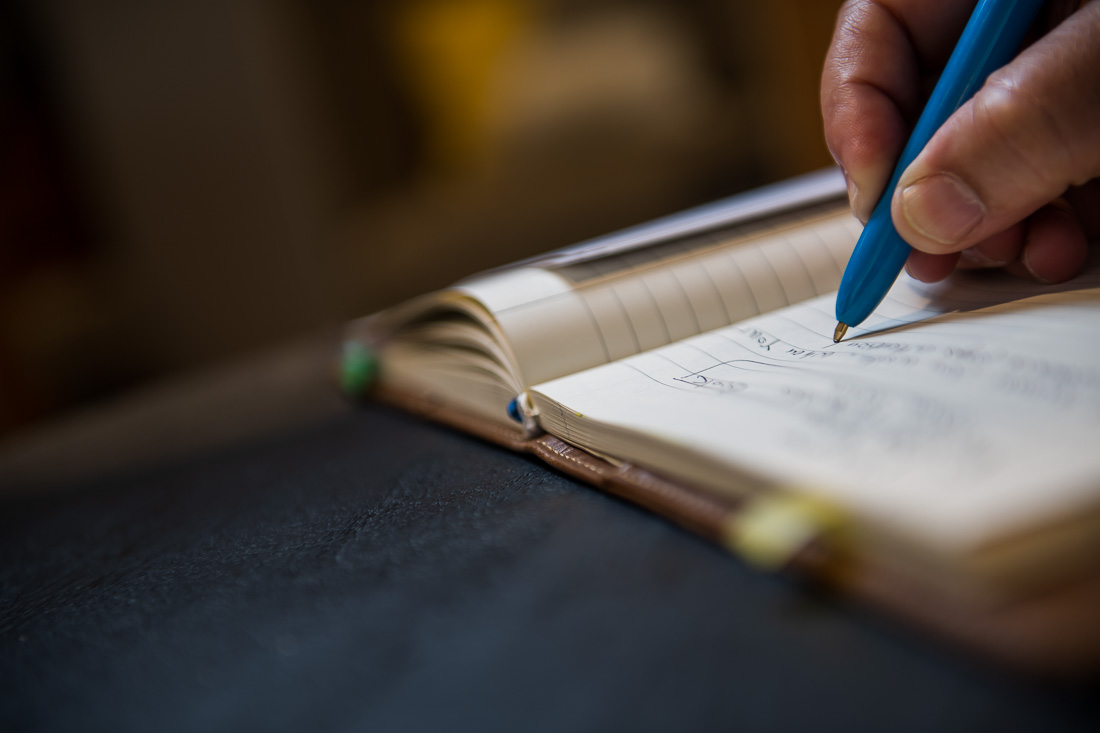 NYC Branded Lifestyle Portraits Sales Executive Speaker Anthony Chaine detail shot of pen writing