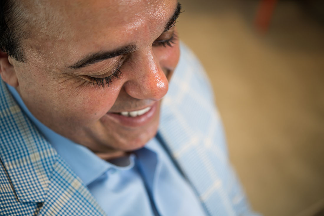 NYC Branded Lifestyle Portraits Sales Executive Speaker Anthony Chaine smiling as he thinks to himself