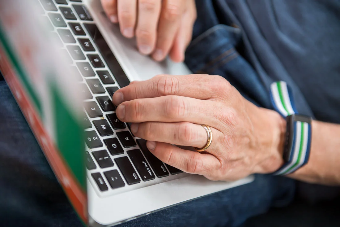 NYC Branded Lifestyle Portraits speaker author coach Michael O'Brien hands close-up on laptop