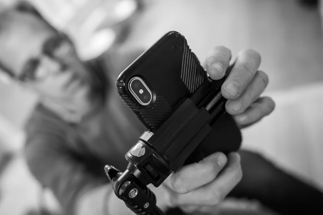 NYC Branded Lifestyle Portraits speaker author coach Michael O'Brien setting up phone for livestream