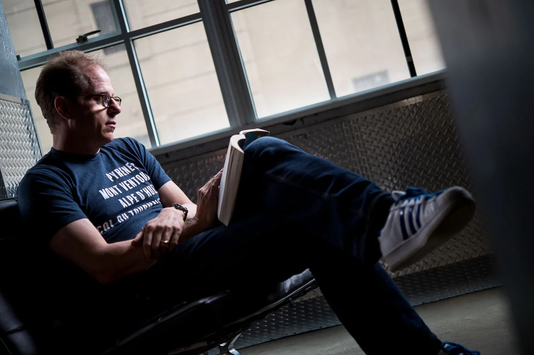 NYC Branded Lifestyle Portraits speaker author coach Michael O'Brien reading a book