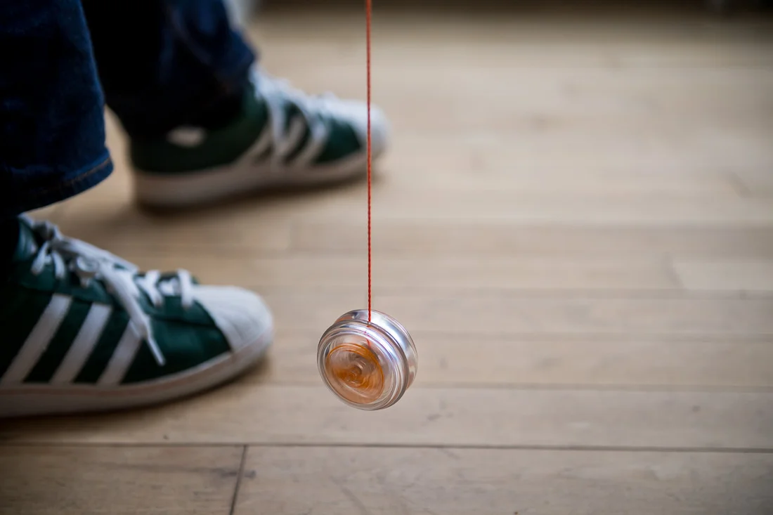 NYC Branded Lifestyle Portraits speaker author coach Michael O'Brien feet close up while playing with yo-yo
