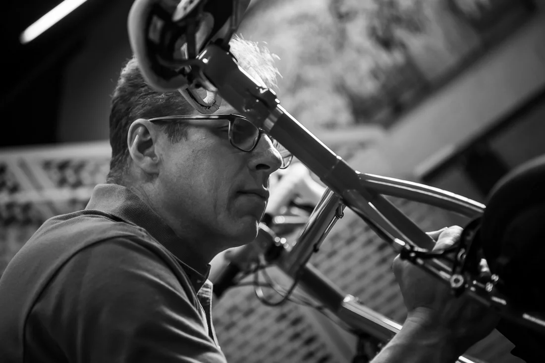 NYC Branded Lifestyle Portraits speaker author coach Michael O'Brien working on his bicycle