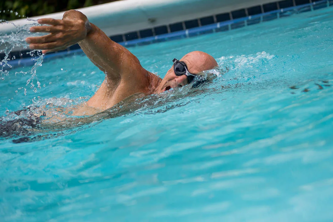 NYC Branded Lifestyle Portraits speaker author Ted Rubin swimming in his pool