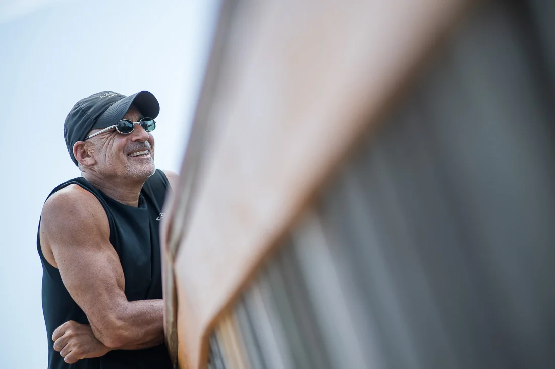 NYC Branded Lifestyle Portraits speaker author Ted Rubin leaning on bridge smiling