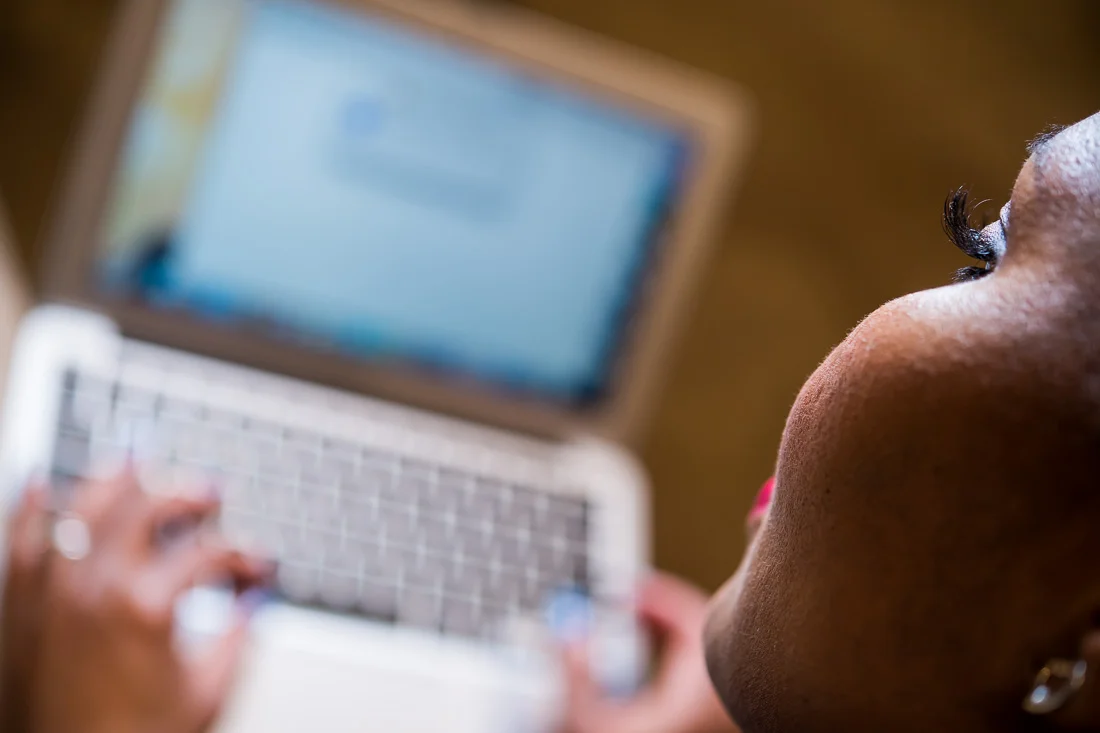 NYC Branded Lifestyle Portraits Lawyer Speaker Chinwe Esimai working on laptop computer