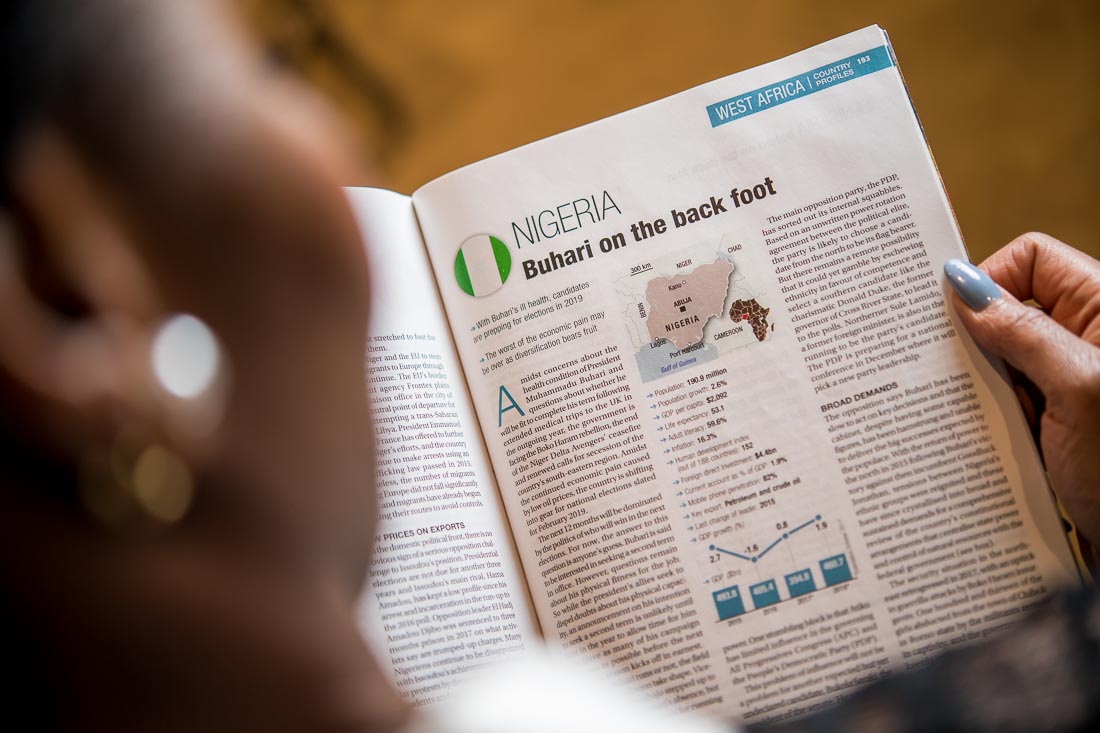 NYC Branded Lifestyle Portraits Lawyer Speaker Chinwe Esimai reading magazine on Nigeria