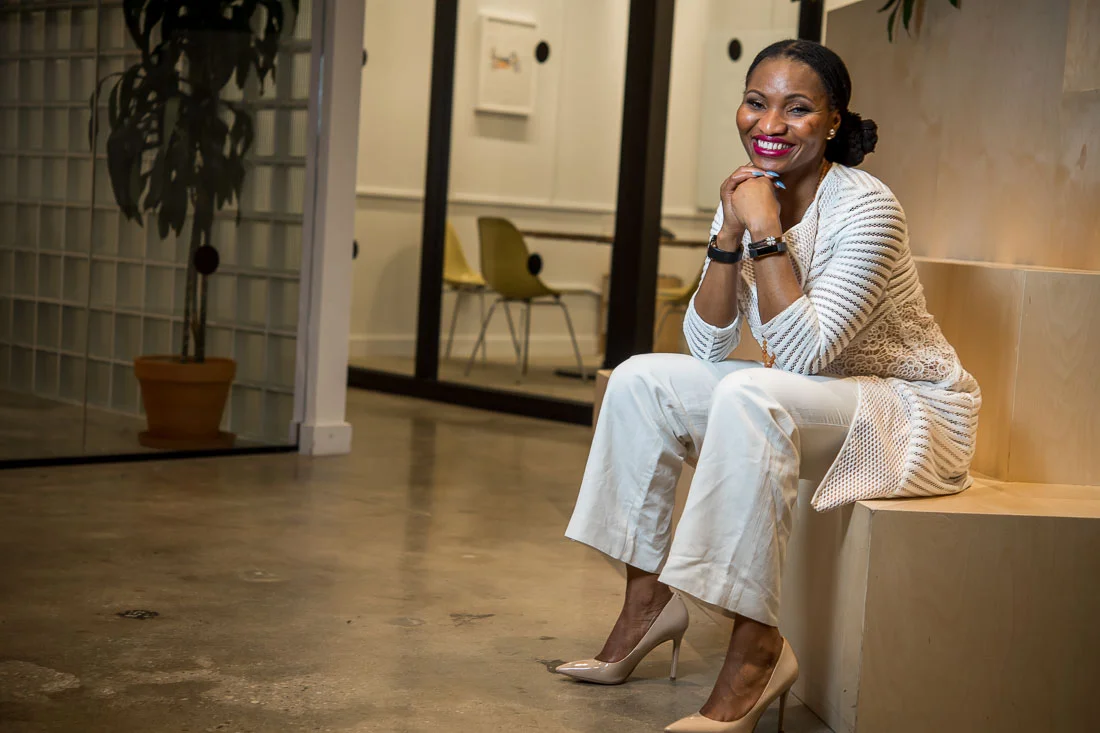 NYC Branded Lifestyle Portraits Lawyer Speaker Chinwe Esimai sitting and smiling for camera
