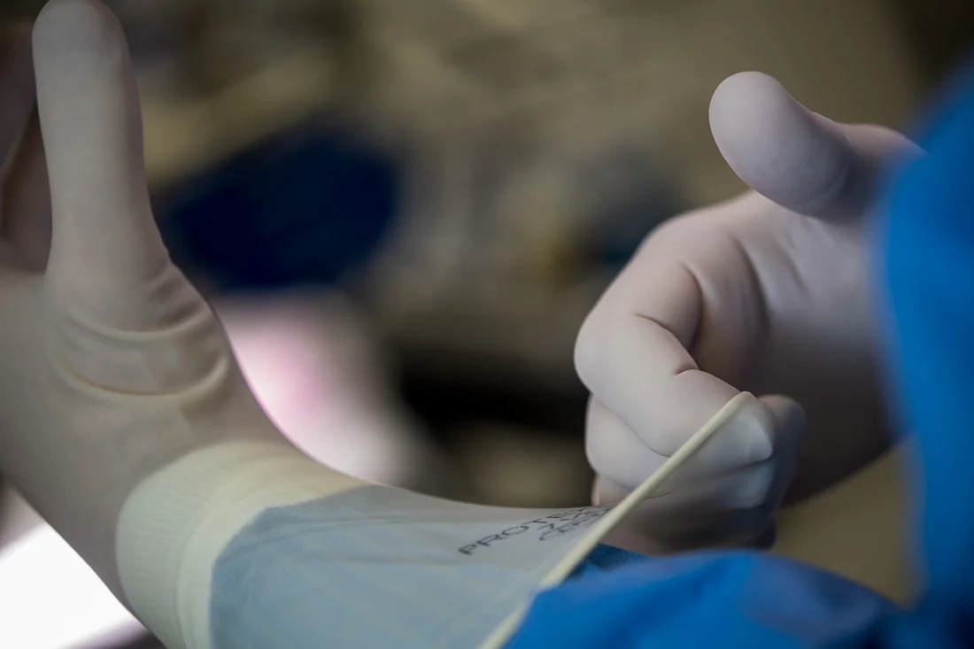 NYC Branded Lifestyle Portraits Doctor Author Dr. Brian Lima putting on gloves before surgery
