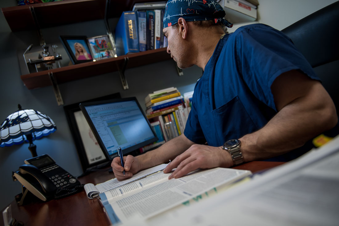 NYC Branded Lifestyle Portraits Doctor Author Dr. Brian Lima researching patient at desk