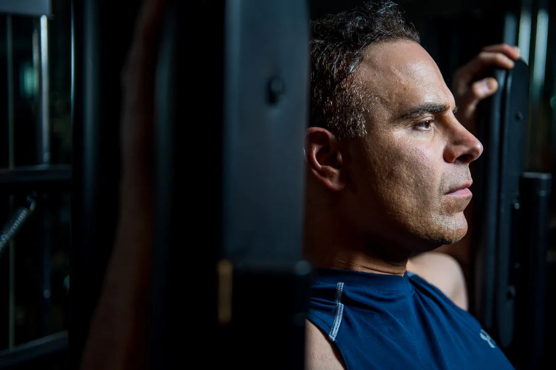 NYC Branded Lifestyle Portraits Doctor Author Dr. Brian Lima working on chest fly machine