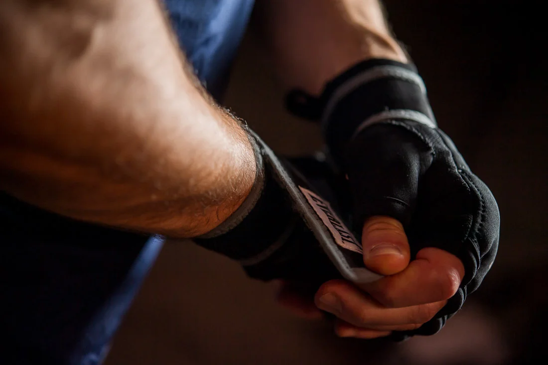 NYC Branded Lifestyle Portraits Doctor Author Dr. Brian Lima putting on boxing gloves