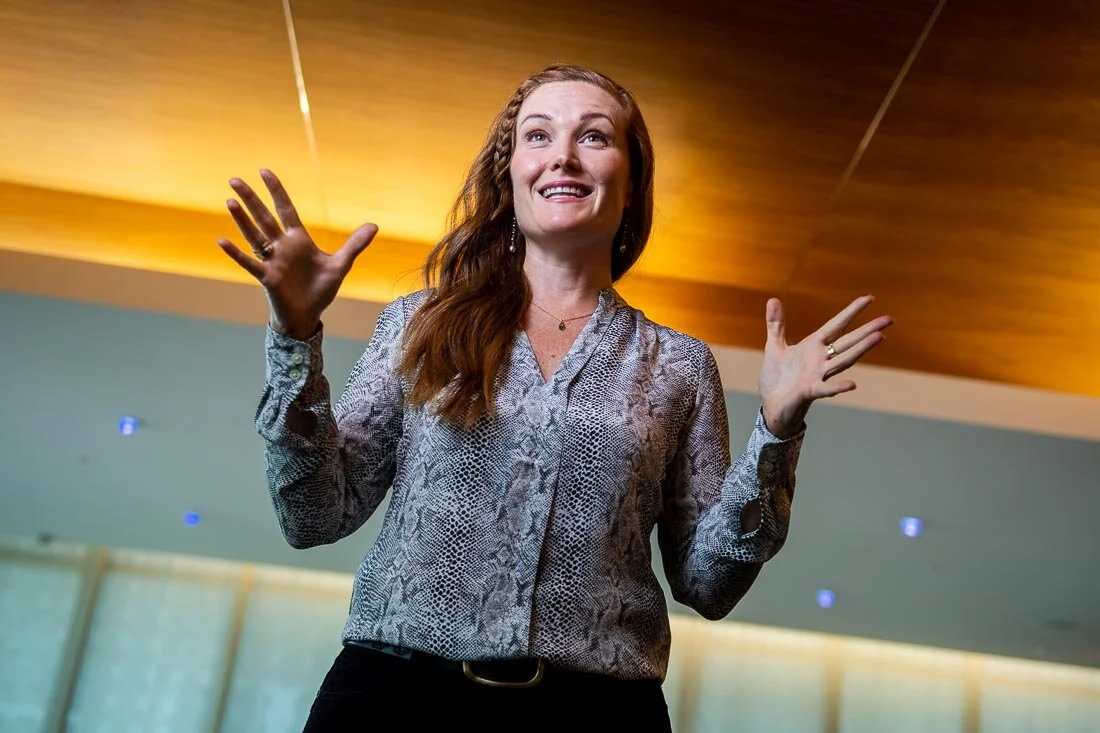 NYC branded lifestyle portrait Speaker Mary Rooney energetically speaking in front of audience