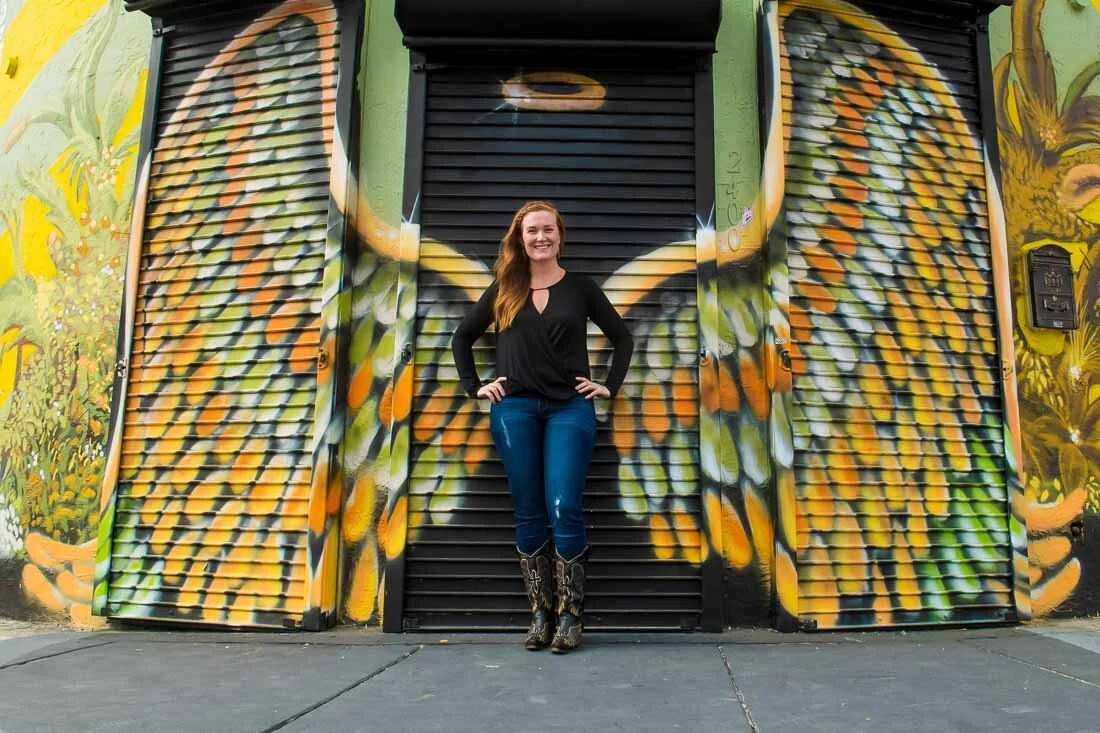 NYC branded lifestyle portrait Speaker Mary Rooney standing in front of graffitti