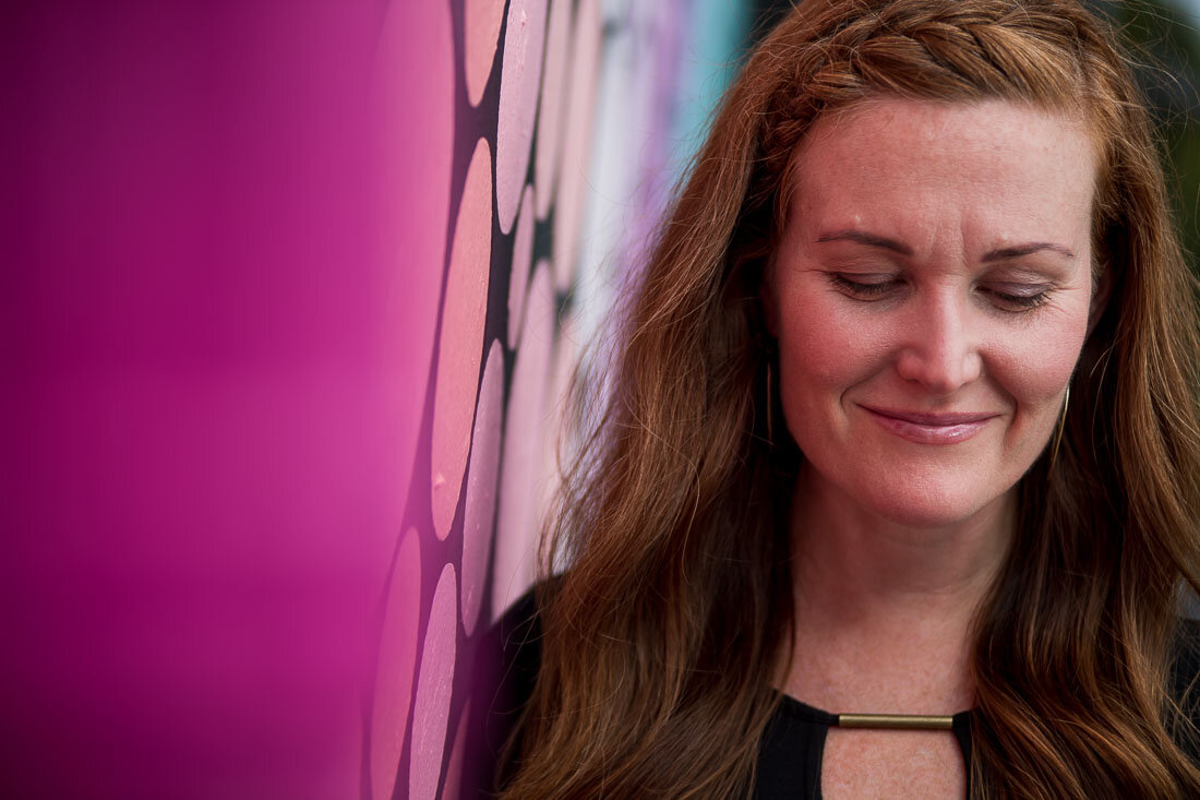 NYC branded lifestyle portrait Speaker Mary Rooney leaning on wall thinking to herself