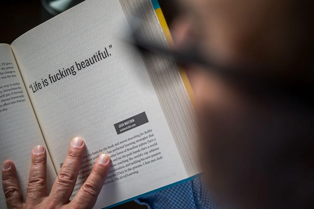 NYC Branded Lifestyle Portrait Howie Doin It Howie Kra flipping through pages of a book