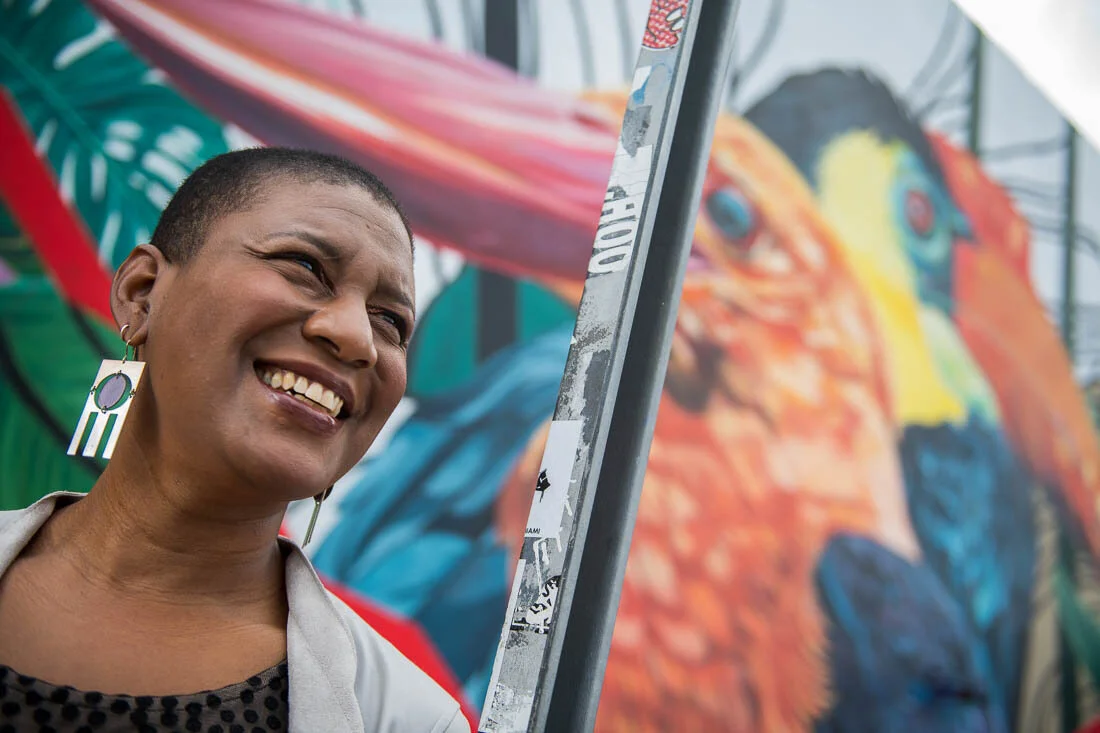 NYC branded lifestyle portrait Speaker Author Denise Jacobs smiling in front of Wynwood walls