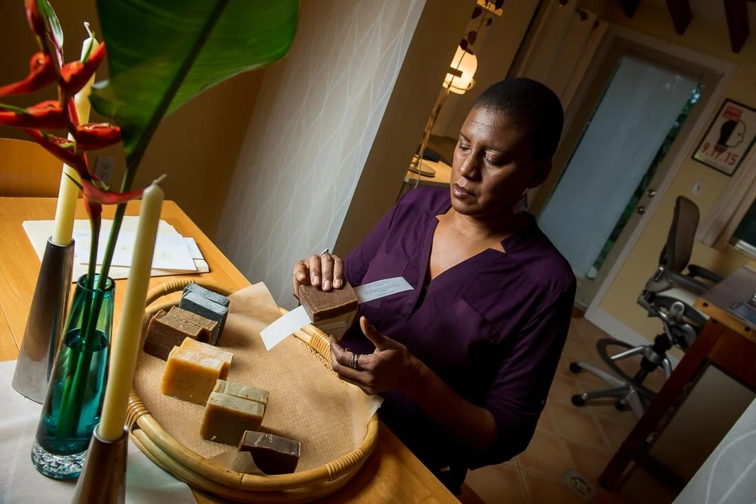 NYC branded lifestyle portrait Speaker Author Denise Jacobs labeling her soap before sending out