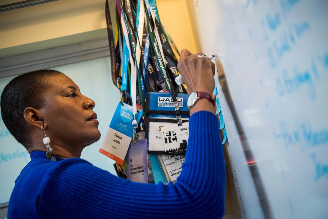 NYC Branded lifestyle portrait Speaker Author Denise Jacobs writing notes on office whiteboard