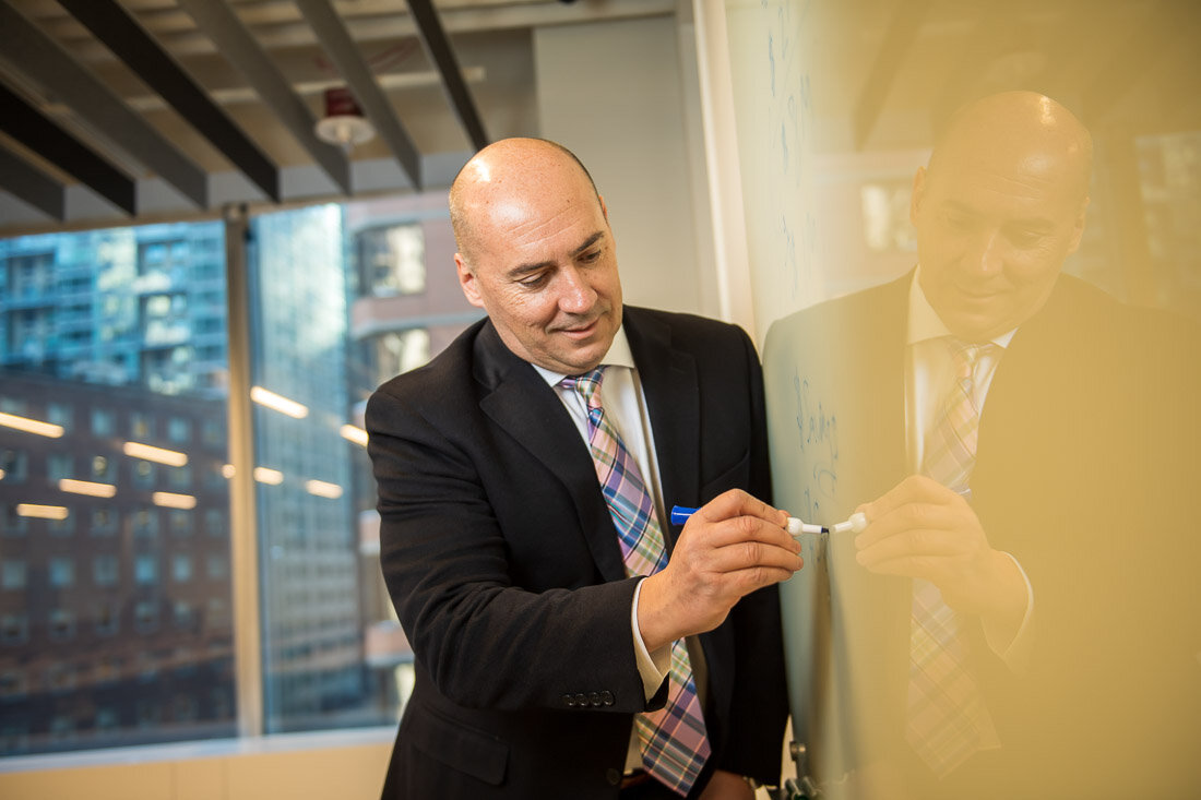 NYC personal branding photography CEO Ray Kober writing on whiteboard