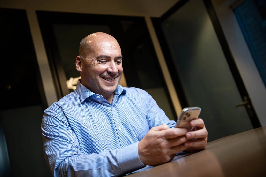 NYC personal branding photography CEO Ray Kober working on his phone