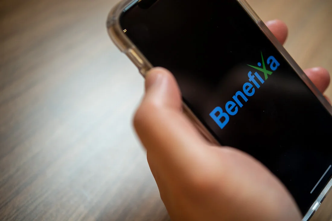 NYC personal branding photography CEO Ray Kober looking at benefixa logo on phone