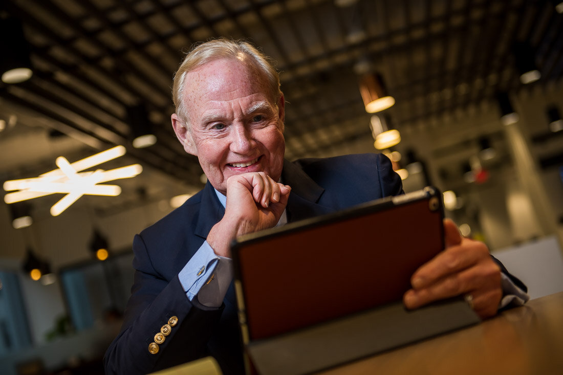 NYC personal branding photography speaker political consultant Jay Townsend smiling while working on laptop