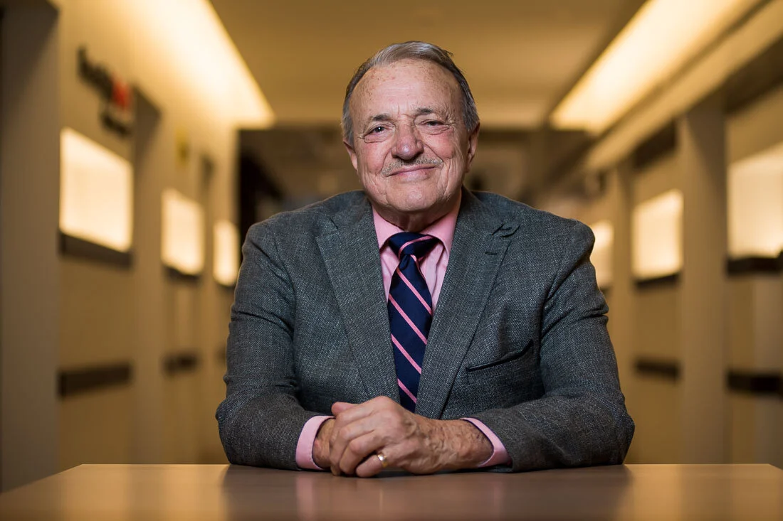 NYC Personal branding photography Speaker Author Tony Morante sitting at table smiling