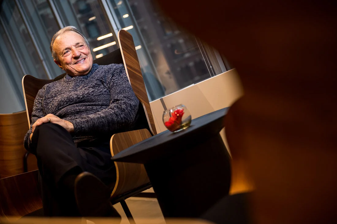 NYC Personal branding photography Speaker Author Tony Morante sitting alone smiling looking out window