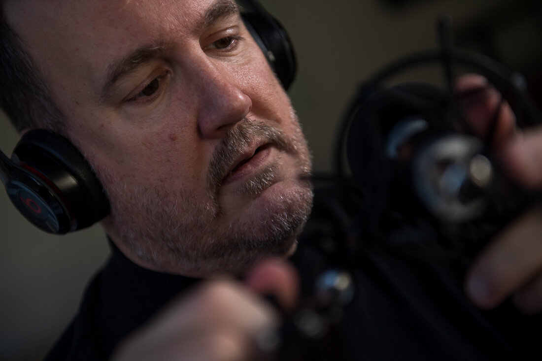 NYC personal branding photography Speaker Consultant Ken Blackwell preparing for podcast with mirophone